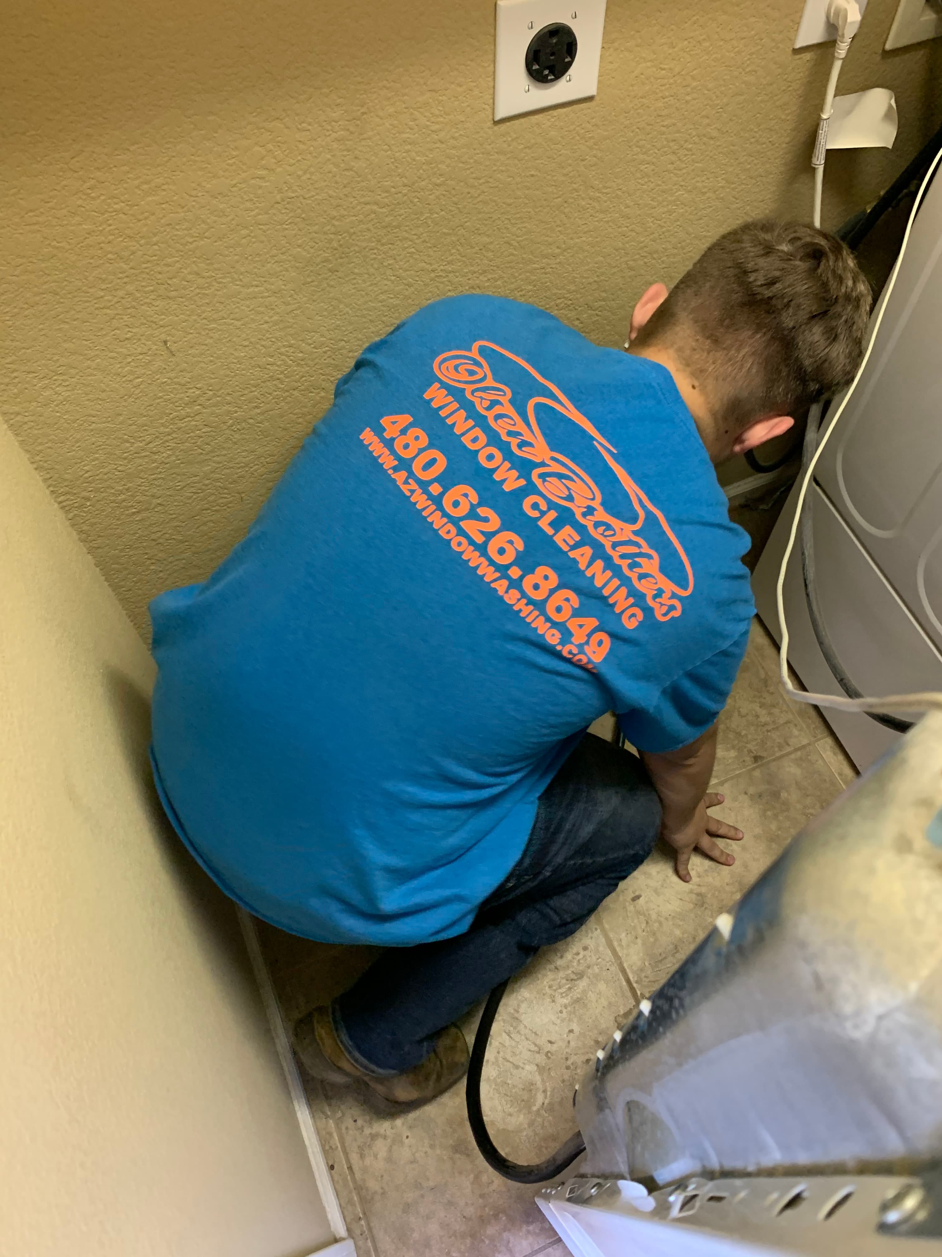 Dryer vent cleaning at a residential home — tools and crew at the curb, East Valley Arizona