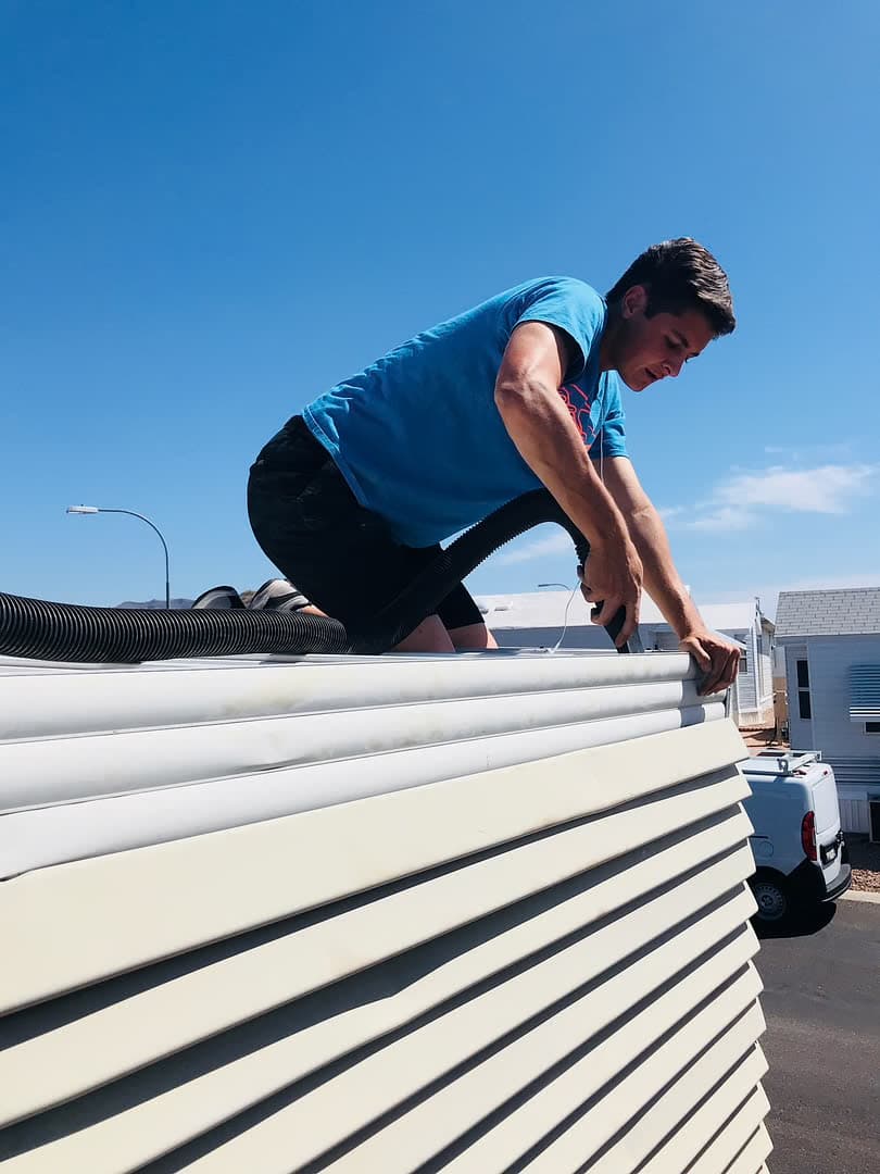 Roof-edge gutter cleaning — tools and access at the fascia, Arizona home