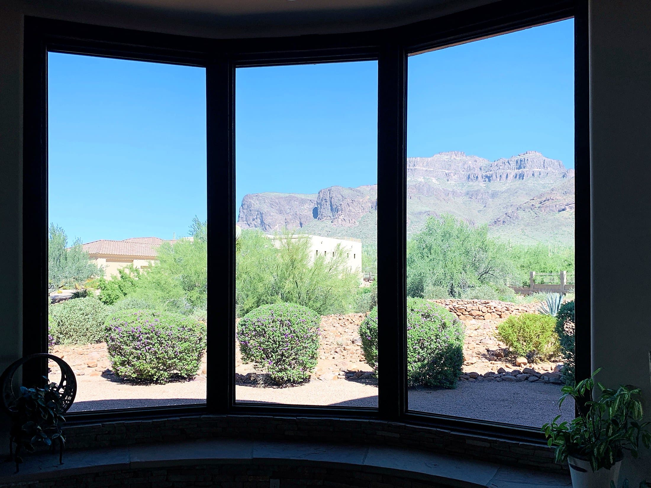 Spotless bay window framing the Superstition Mountains after an Olsen Brothers window cleaning — East Valley, Arizona