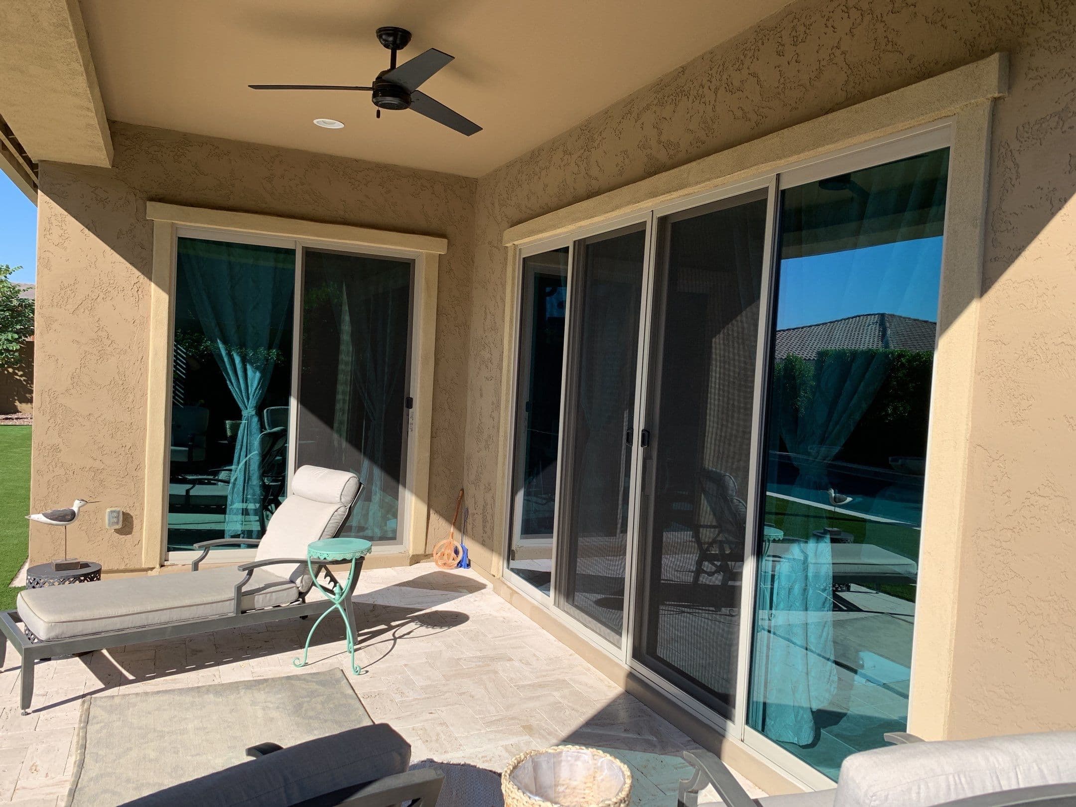 Covered back patio with large sliding glass doors and reflective panes — Eastmark residential job