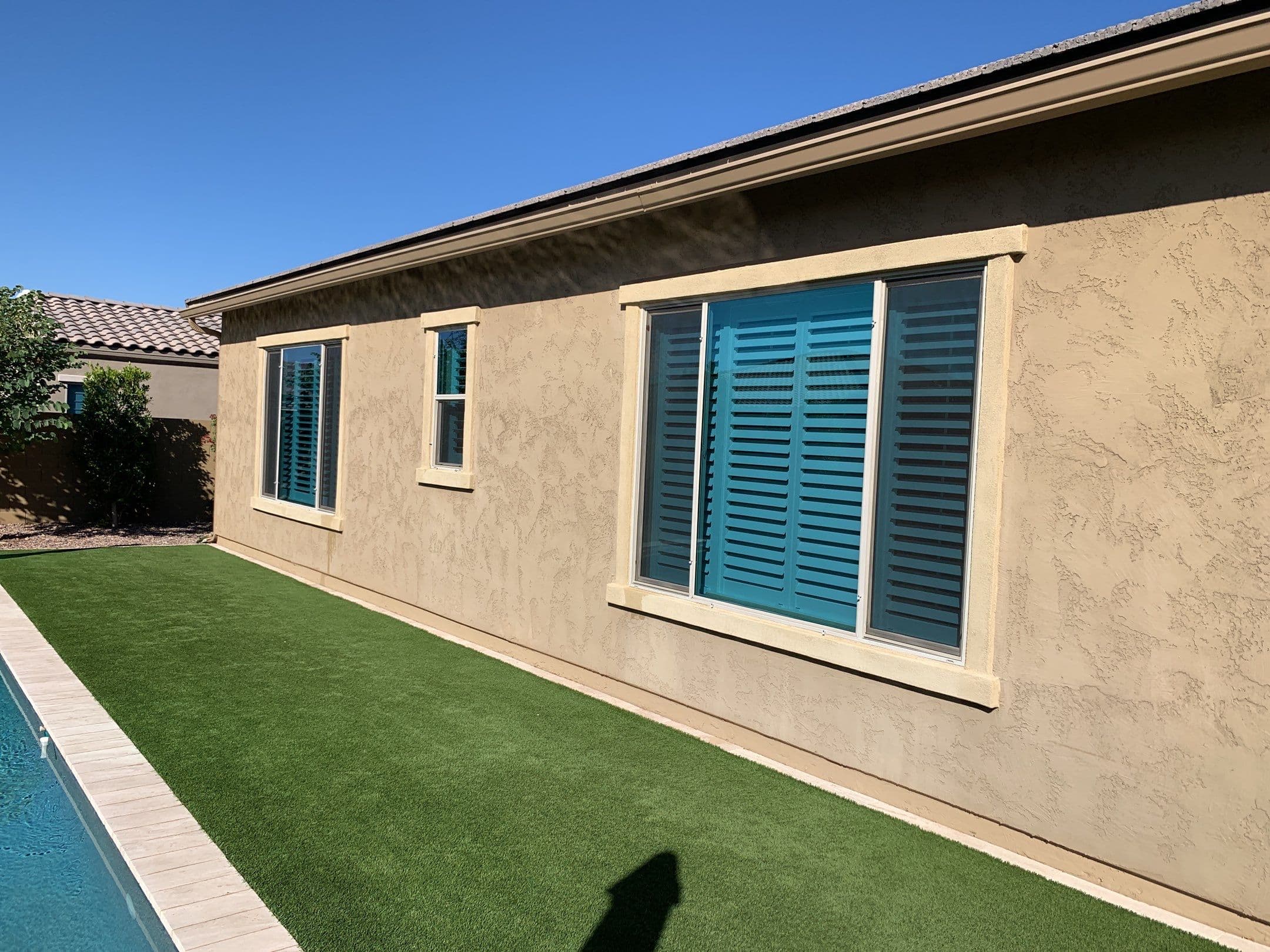 Clean exterior windows along a pool and turf side yard — Eastmark, Mesa
