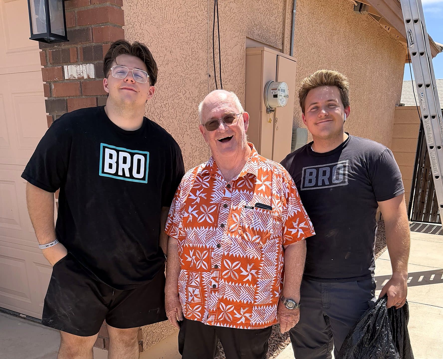 Mack and Kade Olsen in BRO shirts with a happy customer after a window cleaning job in the East Valley